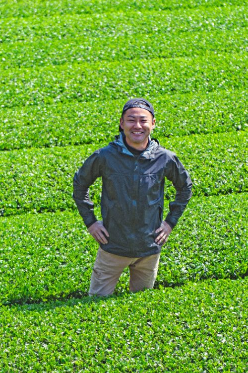 茶畑に笑顔で立つ松永浩二